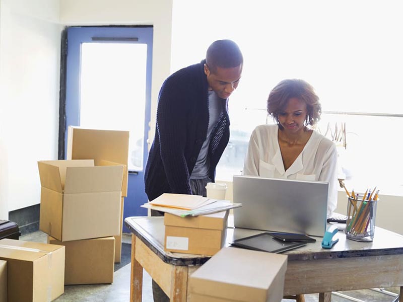 man and woman packing for office move